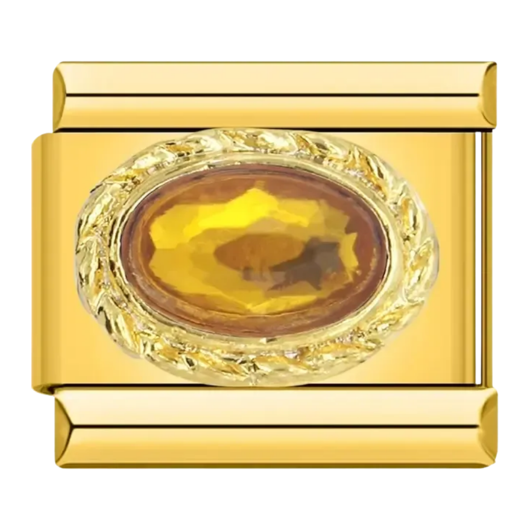 Charm piedra ámbar ovalada en marco dorado texturizado